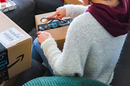 a woman opening an amazon package