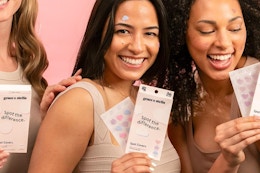 a woman holding grace & stella pimple patches