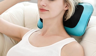 a person laying on a blue and black back massager