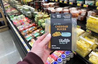 violife just like cheese cheddar slices held in front of walmart produce
