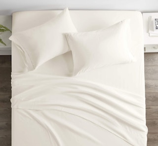 a bed with white bed sheets