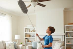 a boy cleaning with a duster