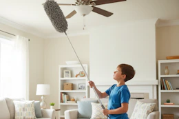 a boy cleaning with a duster
