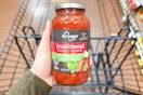 hand holding a jar of kroger pasta sauce