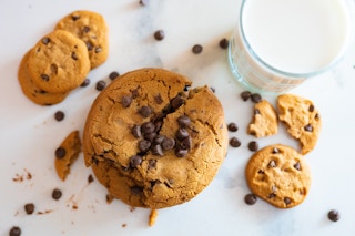 chocolate chip cookie with a glass of milk