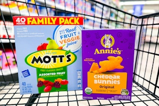 annie's cheddar bunnies crackers and mott's fruit snacks in a shopping cart