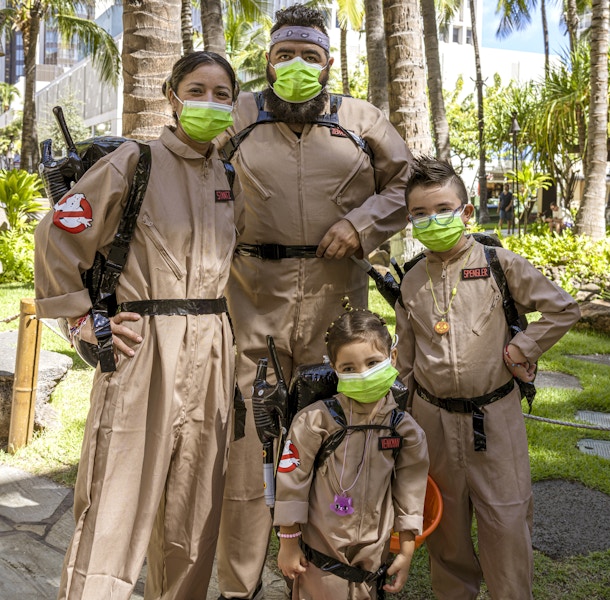 family dressed in Ghostbusters Halloween costumes