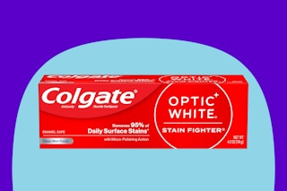 Colgate Optic White Stain Fighter Teeth Whitening Toothpaste on a blue background.