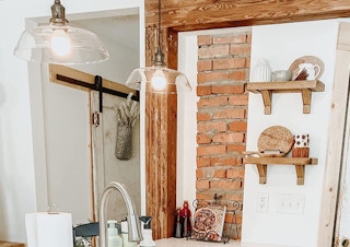 a rustic kitchen with lighting