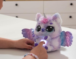 a stuffed unicorn with a light on its belly 