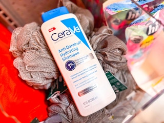 CeraVe Dandruff Shampoo + Conditioner laying over bath loofahs