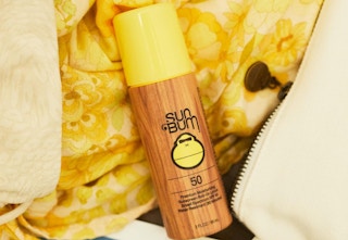 sun bum roll-on lotion resting on clothes
