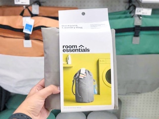 hand holding a room essentials laundry bag at target