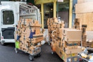 amazon boxes on dollies coming out of a delivery cargo van