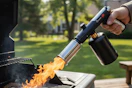 torch gun being used on grill