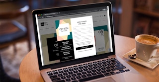 A laptop displaying the sign up form on the Saks off 5th website