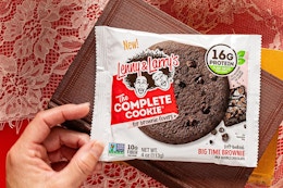 woman holding the brownie The Complete cookie