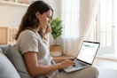 a woman using opinion outpost on her laptop