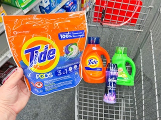 Tide Pods, Tide laundry detergent, Gain laundry detergent, and Downy Unstoppables inside shopping cart