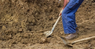 a construction worker shoveling dirt