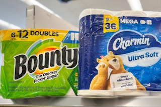 toilet paper and paper towels sitting on store shelf