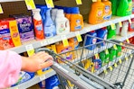 hand pushing a cart in the laundry aisle