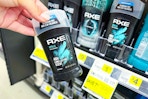 hand holding axe deodorant at dollar general
