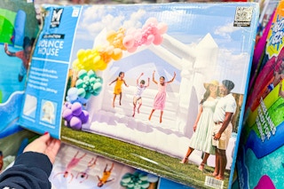hand touching a members mark celebration white bounce house