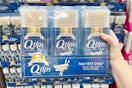 hand holding 3-pack of q-tips at costco