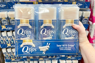 hand holding 3-pack of q-tips at costco