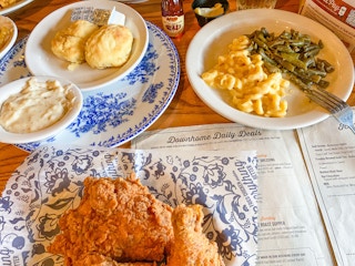 A table at Cracker Barrel covered with plates of different foods from the menu.