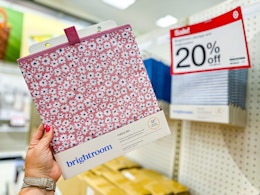 hand holding a brightroom storage cube bin in front of a target shelf