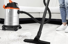 a person using a wet/dry vacuum