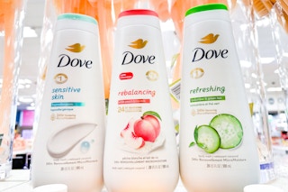 three bottles of dove body wash sitting on a table at target