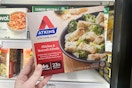 hand holding atkins frozen entree at meijer