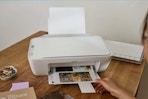 Woman using the HP DeskJet 2827e Wireless All-in-One Color Inkjet Printer.