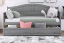 Lifestyle image of the Qualler Twin Daybed in gray (bedroom setting)