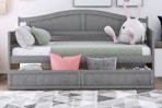 Lifestyle image of the Qualler Twin Daybed in gray (bedroom setting)