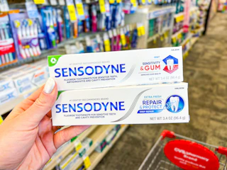hand holding sensodyne toothpastes in cvs