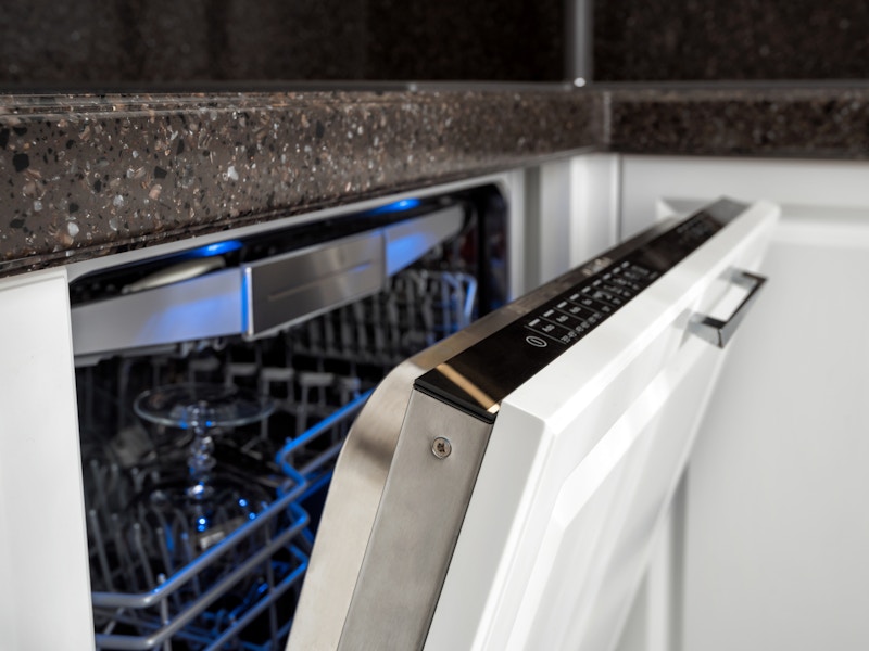 A dishwasher with the door open, showing the settings buttons.