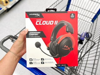 hand holding package of a red and black gaming headset
