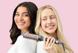 two women with a heated hair brush 