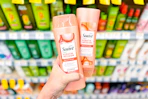 hand holding two suave keratin infusion shampoos