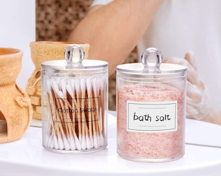 Two apothecary jars on a counter.