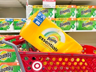 A Bounty essentials package sitting in a store shelf with other Bounty products in the background.