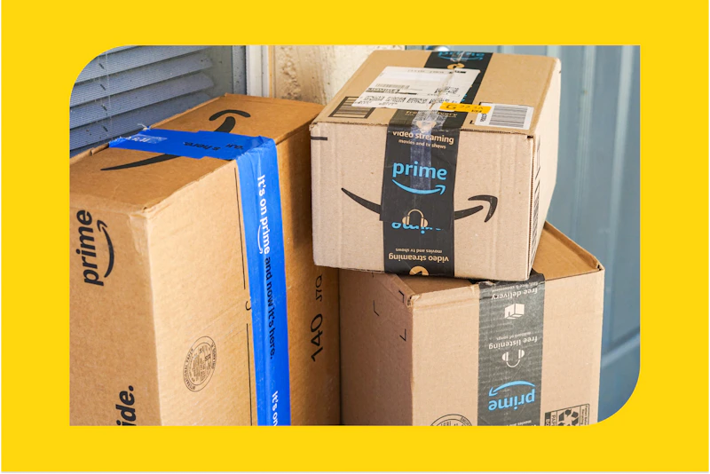 joanie holding amazon boxes on a porch