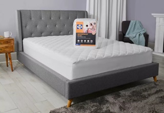 sealy mattress pad sitting on a bed