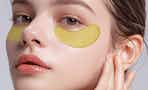 gold under-eye patches on a woman's face
