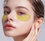 gold under-eye patches on a woman's face
