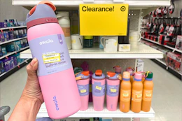 Owala water bottle held up in front of clearance sign in Target store
